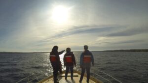 College students riding a boat for water studies course in Traverse City, Michigan