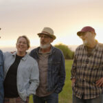 Willey family band standing in a Michigan field at sunset