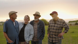Willey family band standing in a Michigan field at sunset