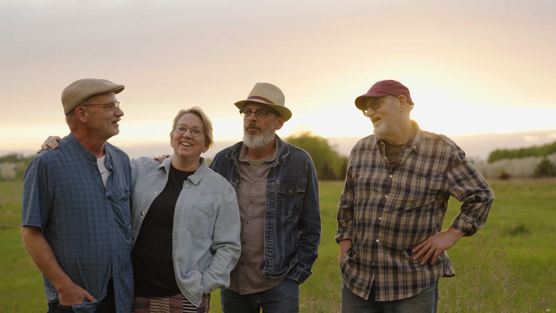 Willey family band standing in a Michigan field at sunset