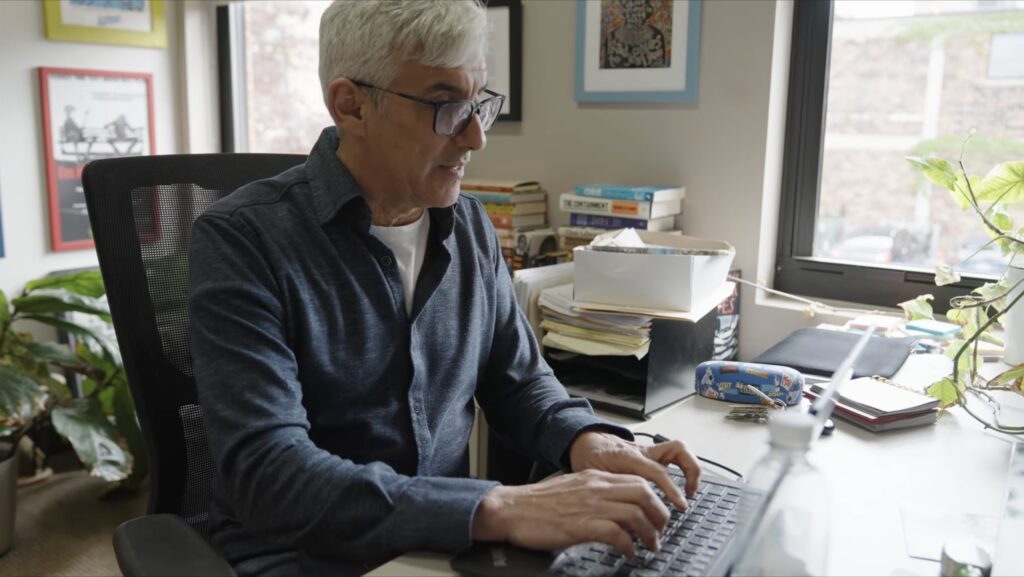 video still of man working in office