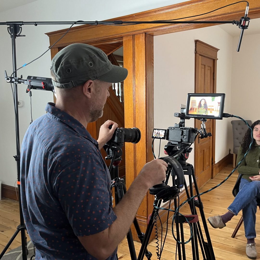 film director adjusting camera in home video studio