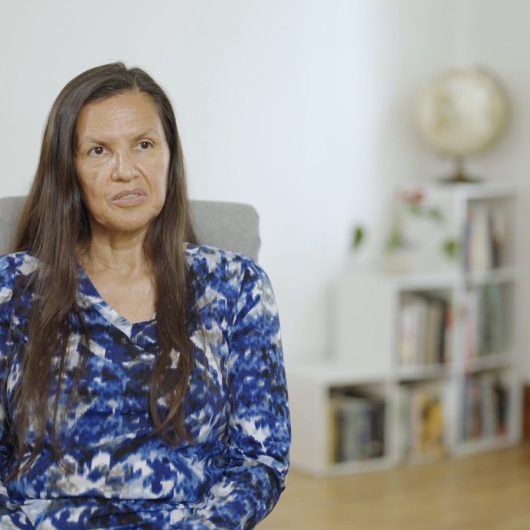 native american woman sitting for an interview on camera